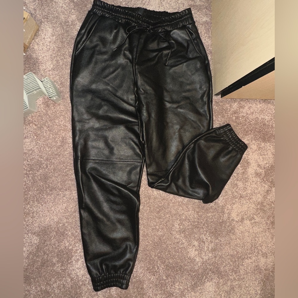 faux Leather trousers with a drawstring waist and cuffed ankles.